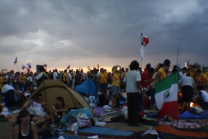 Pilgrims crowd among the grounds at Quatro Vientos at sundown, waiting for the pope to arrive.